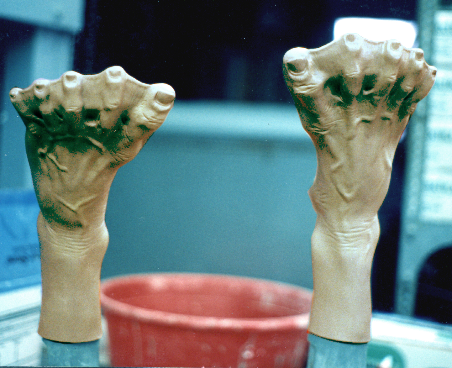 A pair of webbed silicone prosthetic feet on stands in the Lowtech shop, fabricated for Kevin Costner's character in Waterworld